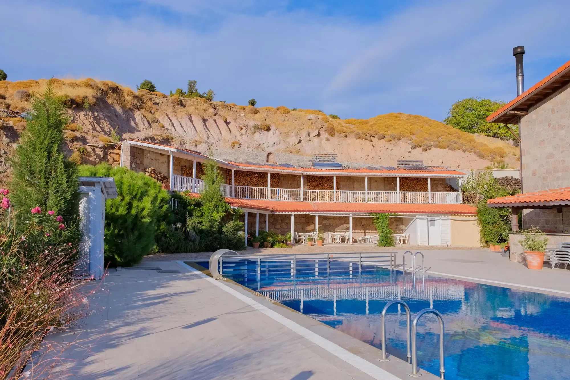 Bahçe, havuz ve taş otel binası